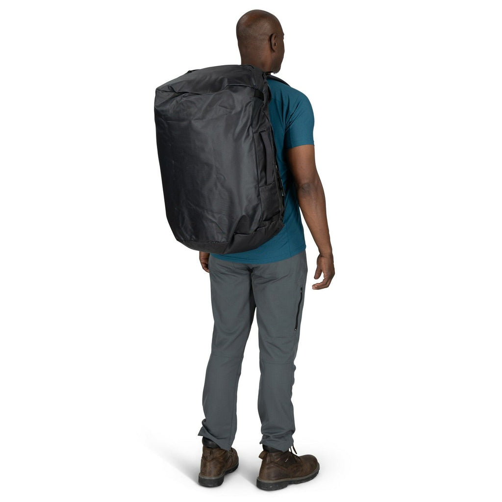 Image of model wearing the Transporter Duffel 65 in the color Raven Black