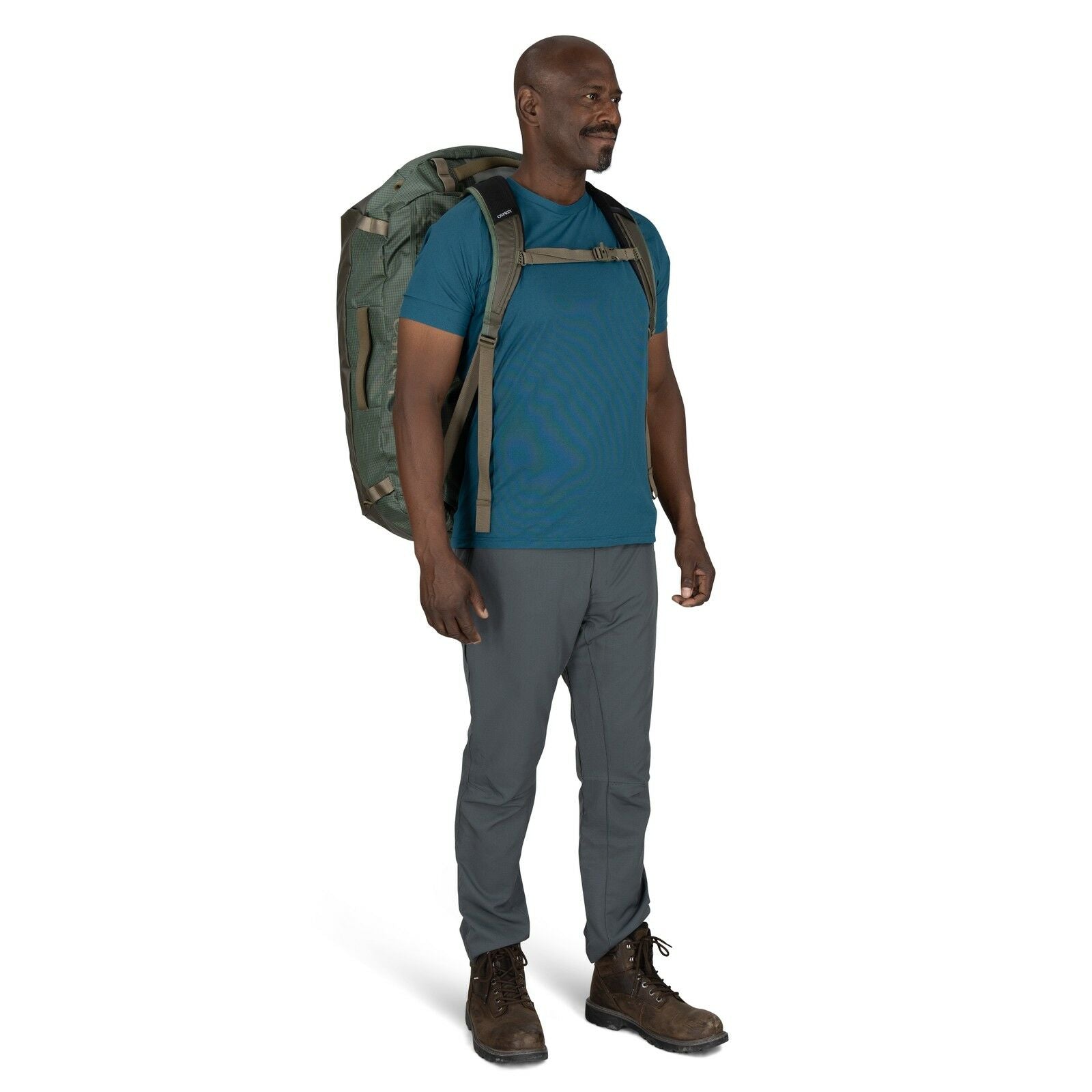 Image of model wearing the Transporter Duffel 95 in the color Pine Leaf / Earl Grey