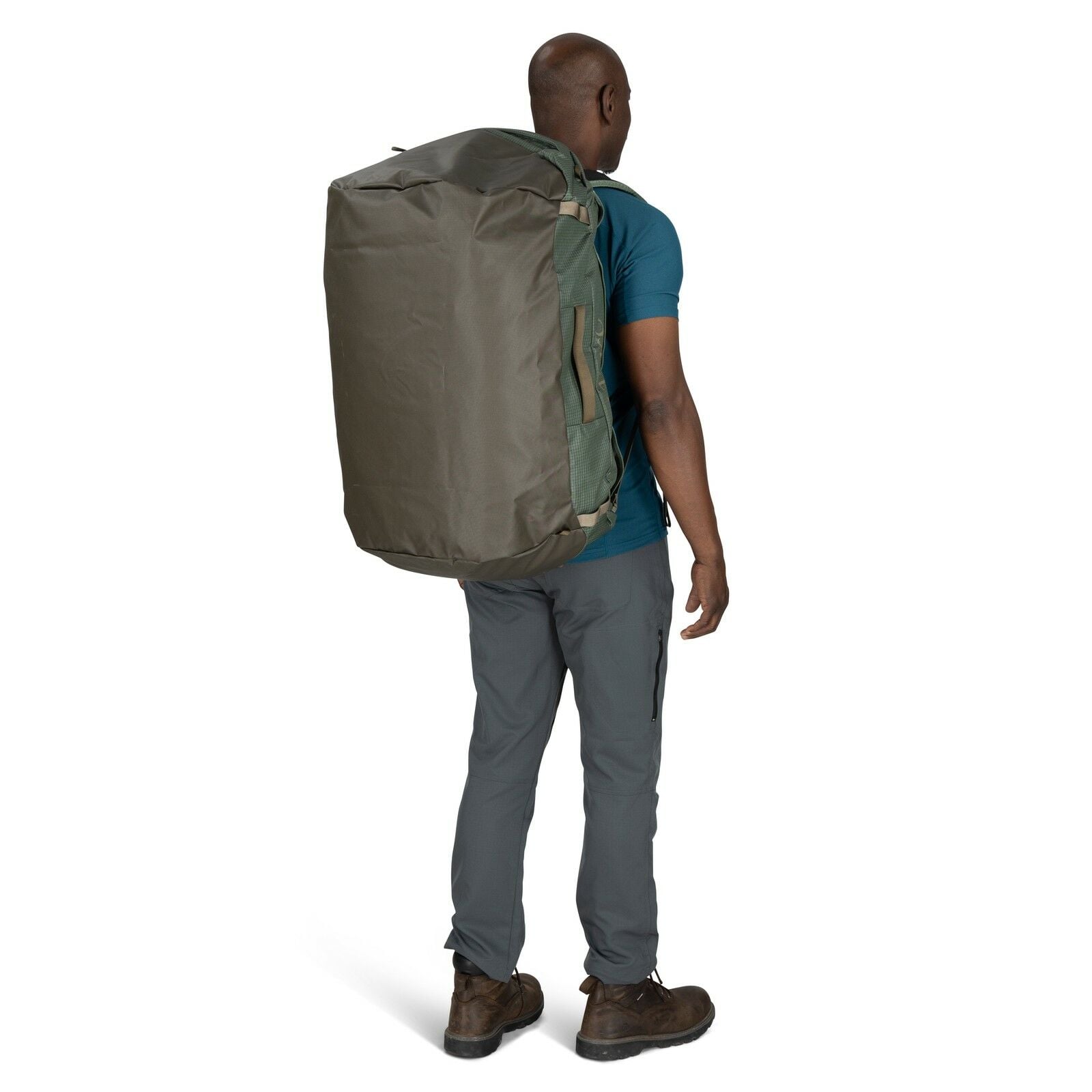 Image of model wearing the Transporter Duffel 95 in the color Pine Leaf / Earl Grey