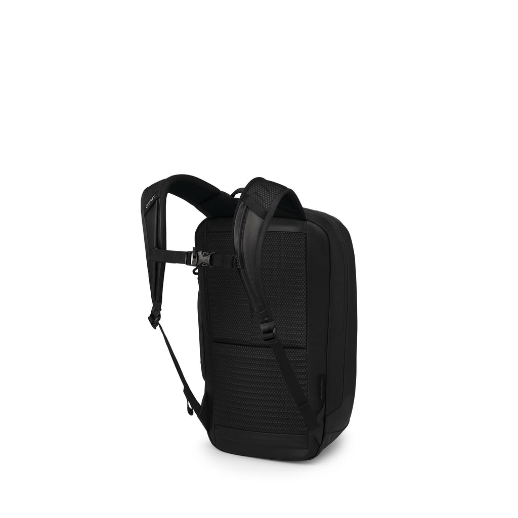 The image shows a sleek black backpack viewed from the back and side. It has padded, breathable mesh back panels and contoured shoulder straps with an adjustable sternum strap. The pack has a streamlined, rectangular shape with minimal seams and a reinfor