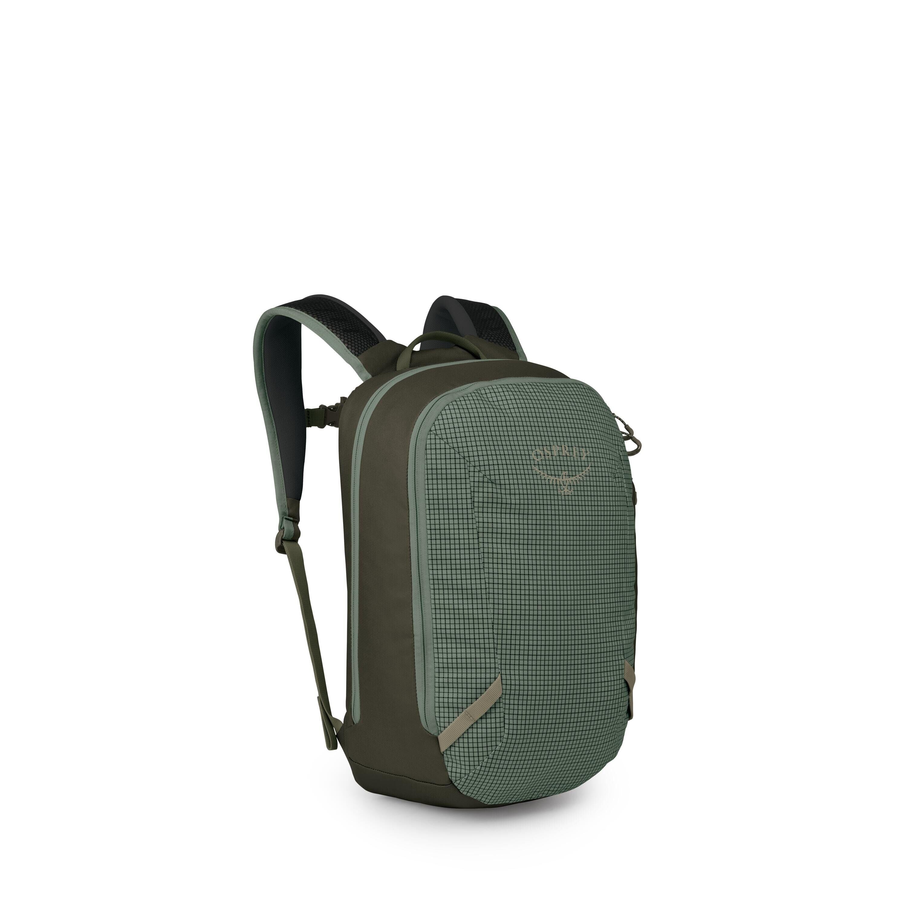 A compact, forest-green backpack is shown at a three-quarter angle on a white background. It features a textured grid front panel with the Osprey logo, contrasted by darker green sides and base. The pack has padded shoulder straps with breathable mesh, du