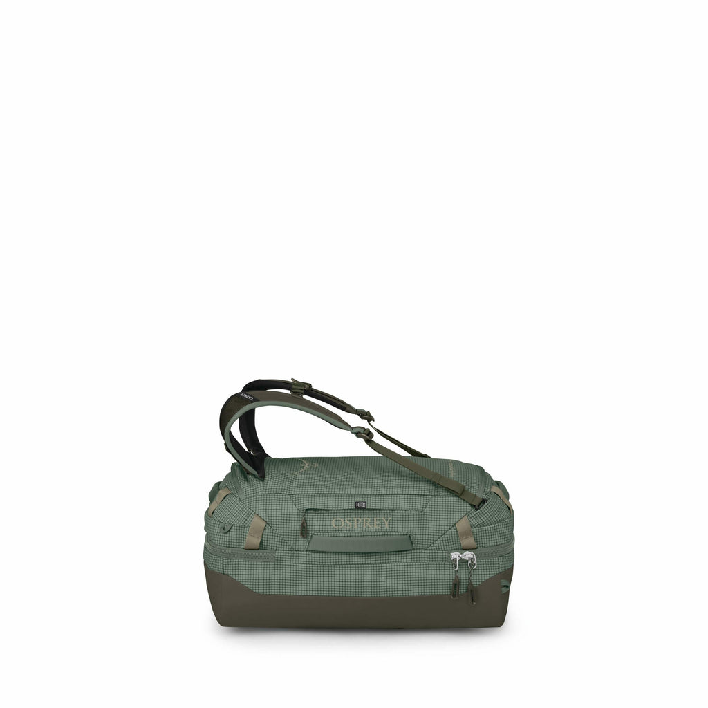 The image series shows a green Osprey duffel bag from multiple angles and in various stages of collapse or compression, likely demonstrating its collapsible or compressible nature for compact storage. The bag features a checkered design with durable mater