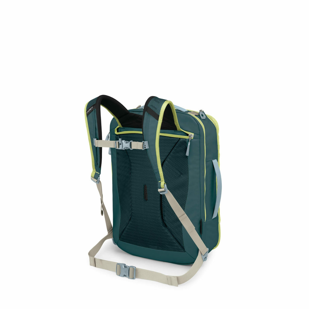The image features a backpack with a unique box-like shape, displayed from the back side to highlight its shoulder straps and mesh padding for comfort. The backpack is primarily a deep teal color, complemented by bright lime green accents and beige adjust