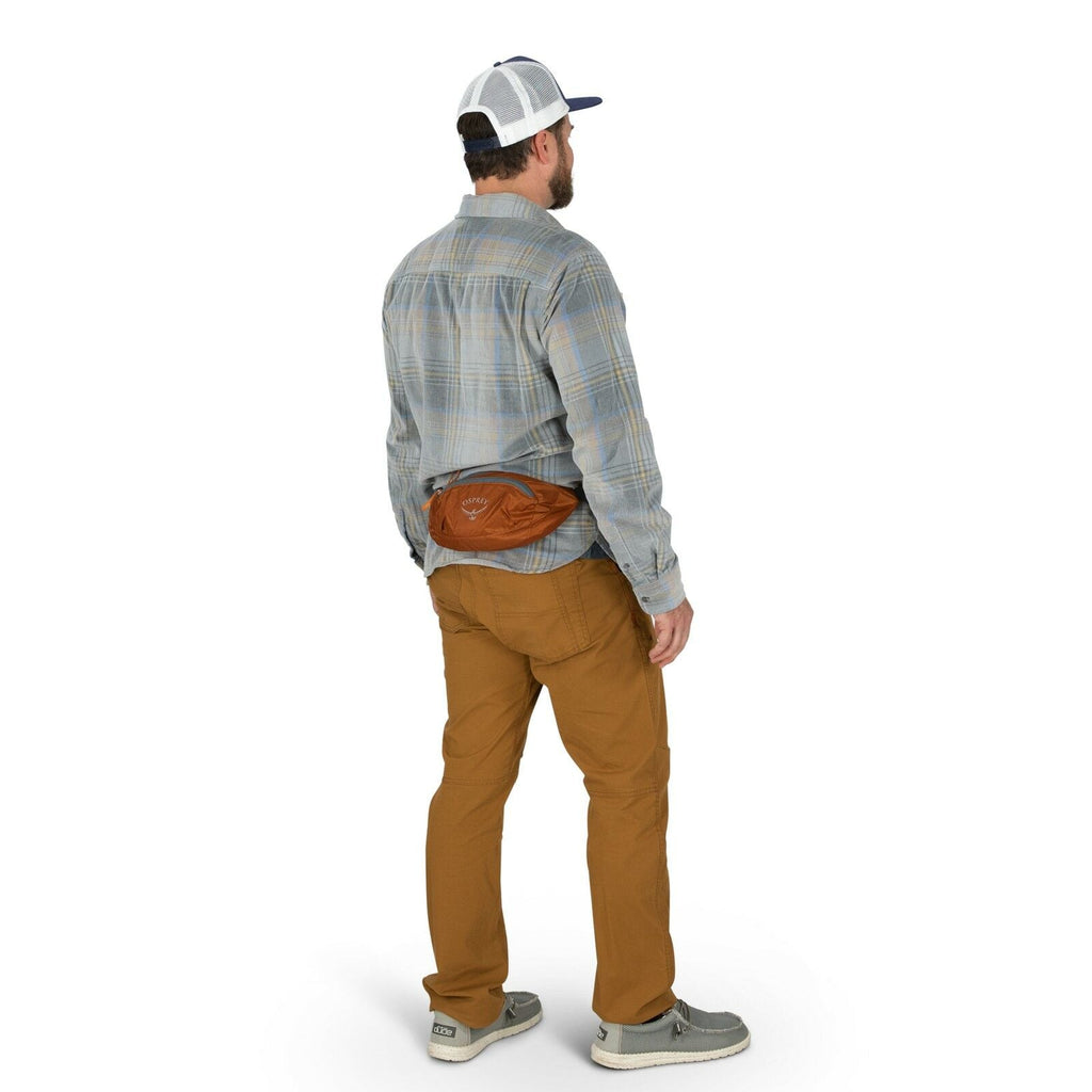 a person modeling the Ultralight Stuff Waist Pack in color toffeeorange