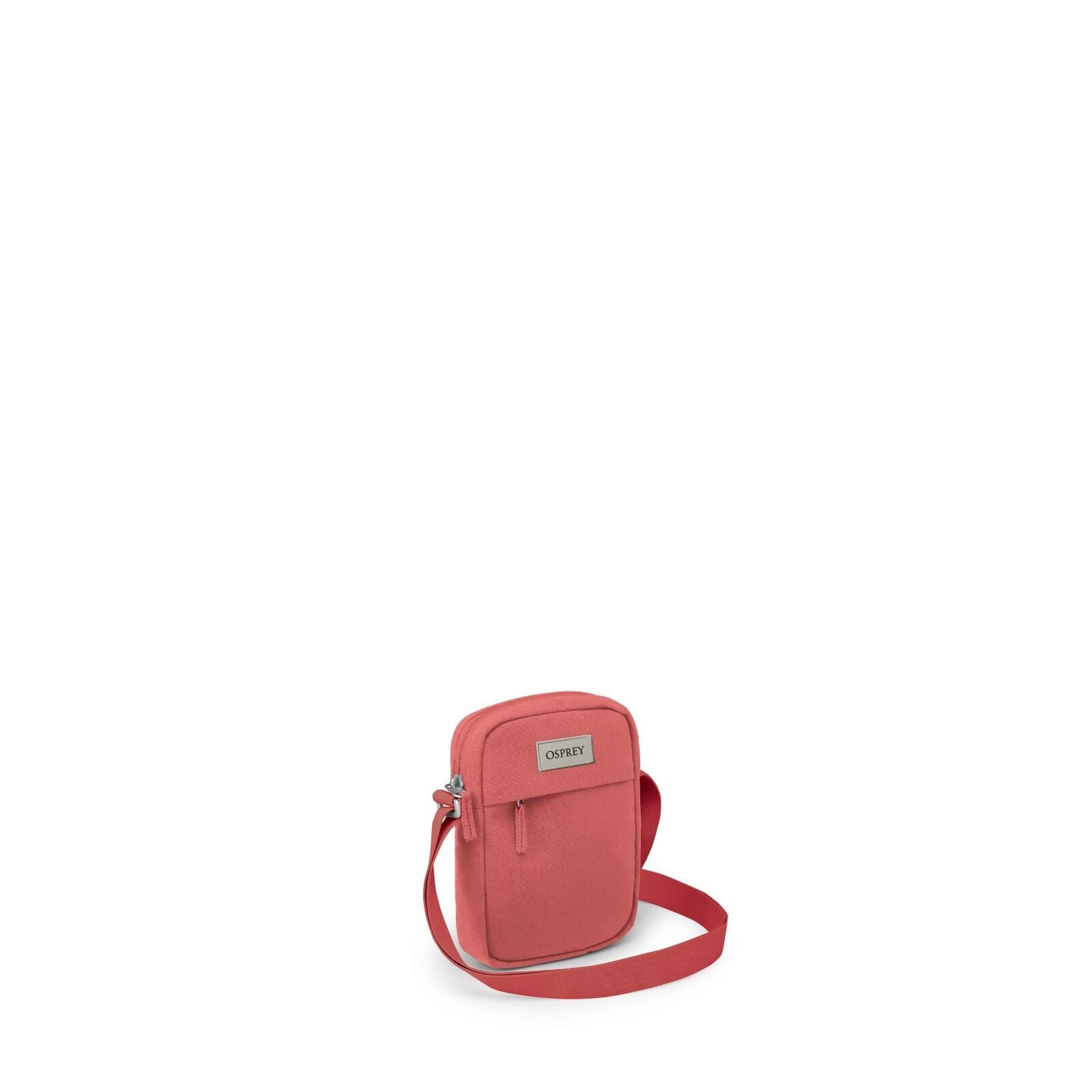 The image features a compact, coral-colored shoulder bag, likely designed for everyday use or travel. It is a small crossbody bag with a main compartment secured by a zipper, and it seems to have a front pocket also with a zip closure. The bag is accented