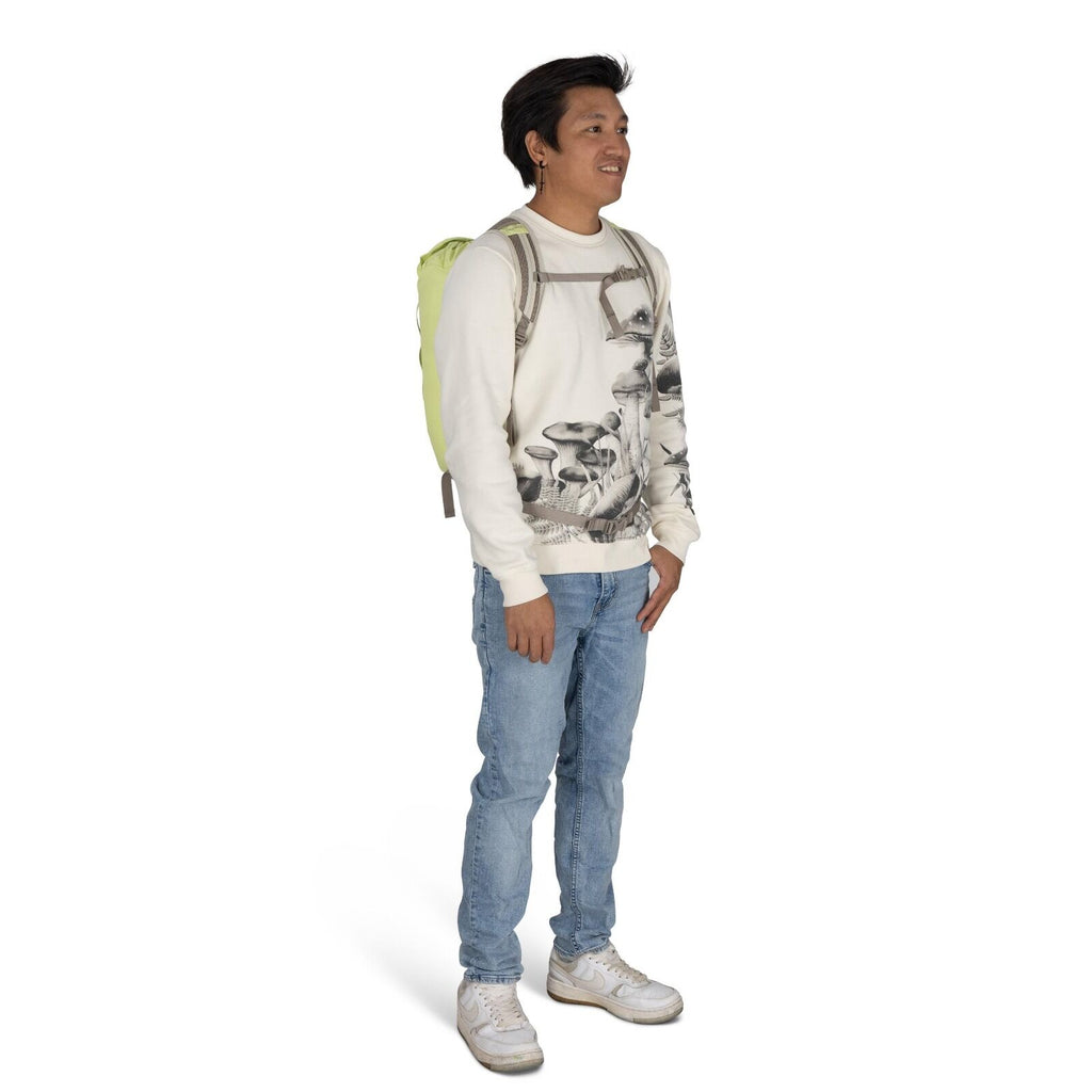 The image shows a person standing and wearing a casual outfit. They have on a white sweatshirt with a detailed black-and-white mushroom print design. The person is also wearing light blue jeans and white sneakers, creating a relaxed and comfortable look.