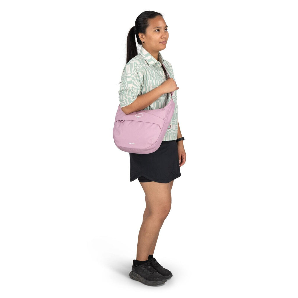 The image shows a person standing and modeling with a casual, sporty outfit. The individual is wearing a mint green and white patterned button-up shirt with rolled-up sleeves, paired with a black skirt. They are also wearing black athletic shoes with blac