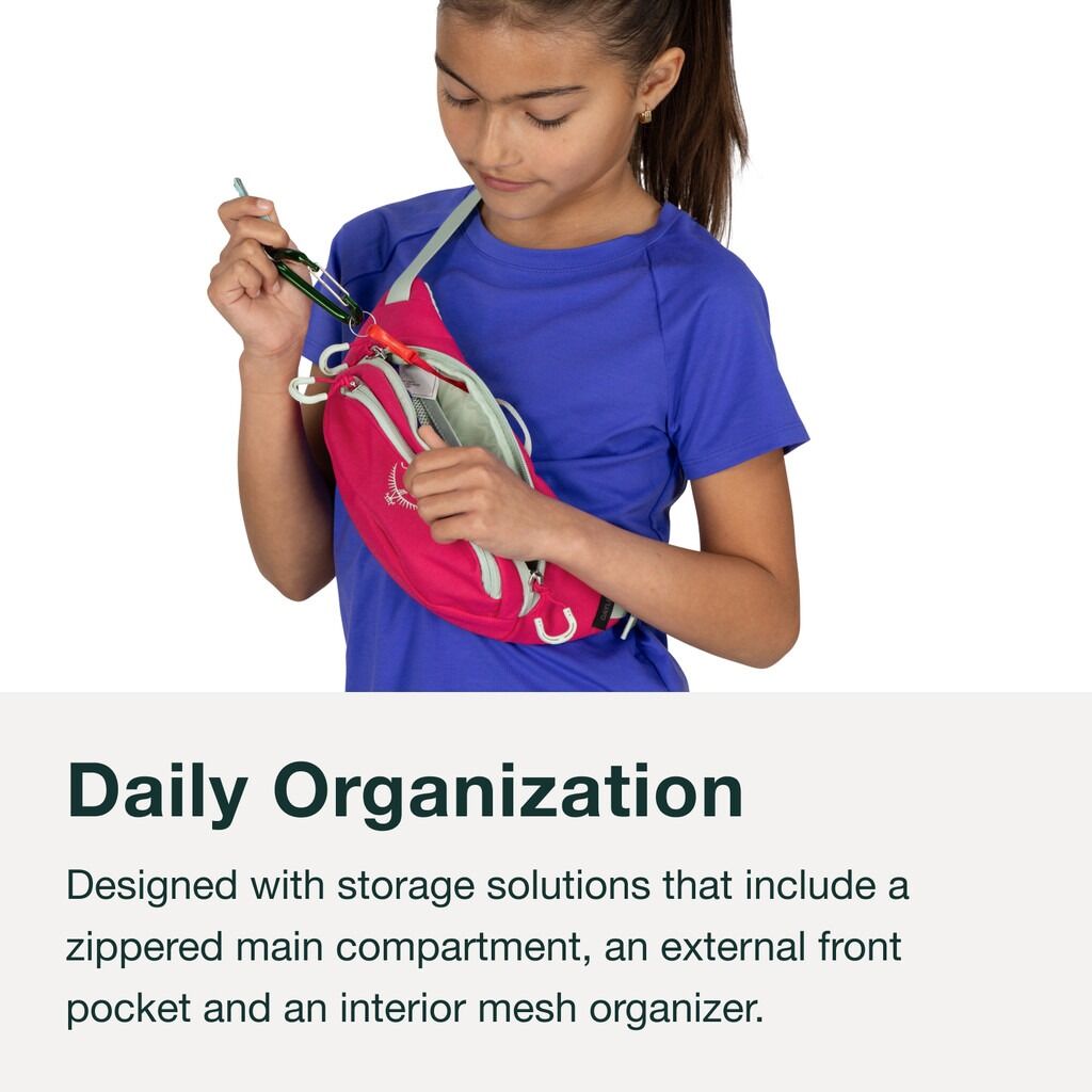 Girl wearing pink Osprey Daylite Hip Pack, accessing zippered pocket.