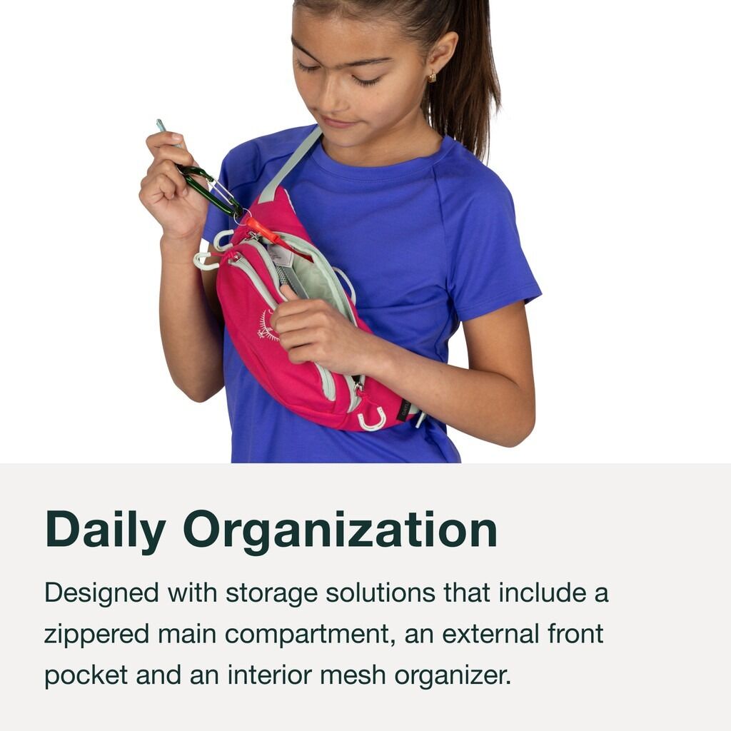 Girl wearing pink Osprey Daylite Hip Pack, accessing zippered pocket.