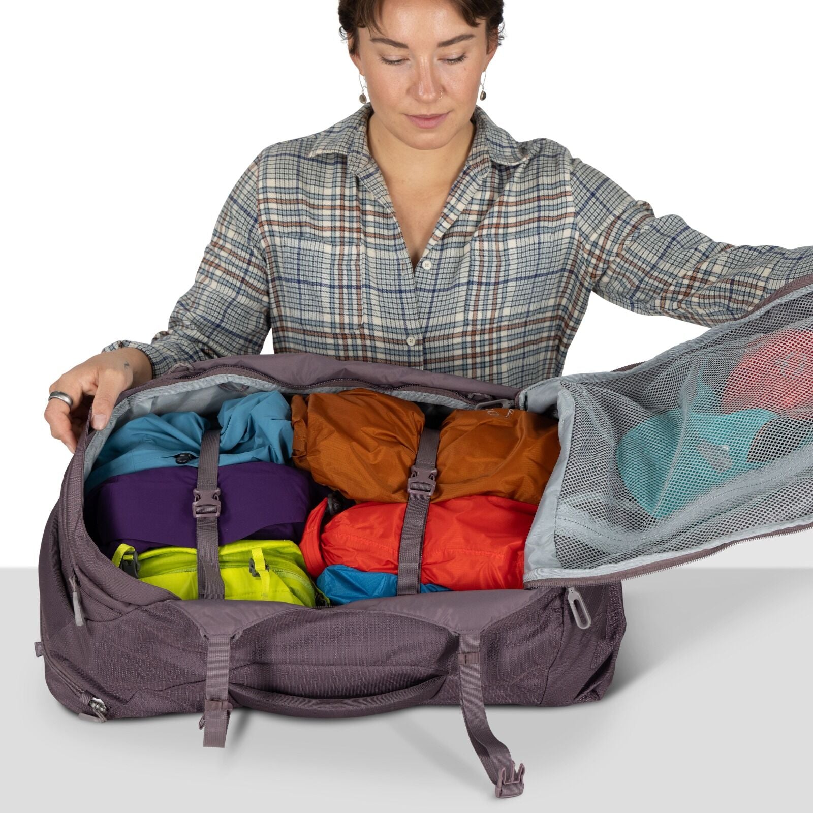 A model showing detailed images of the Fairview 40 Travel pack in the color Graphite Purple.