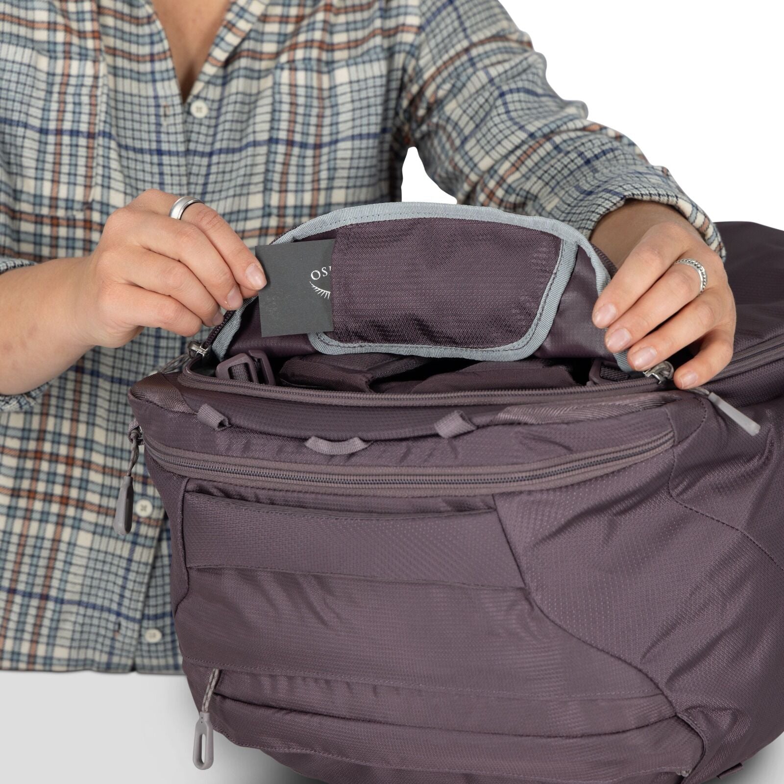 A model showing detailed images of the Fairview 40 Travel pack in the color Graphite Purple.