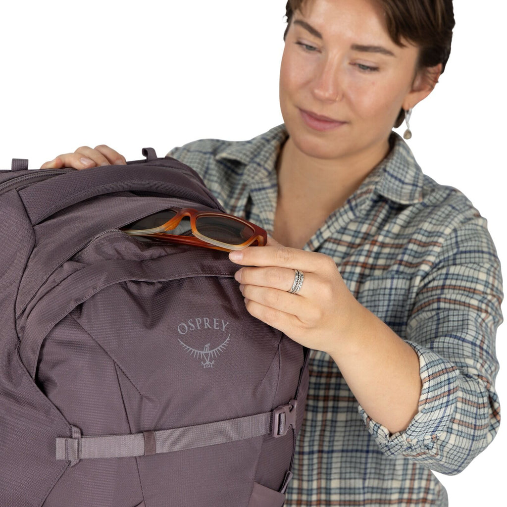 A model showing detailed images of the Fairview 40 Travel pack in the color Graphite Purple.