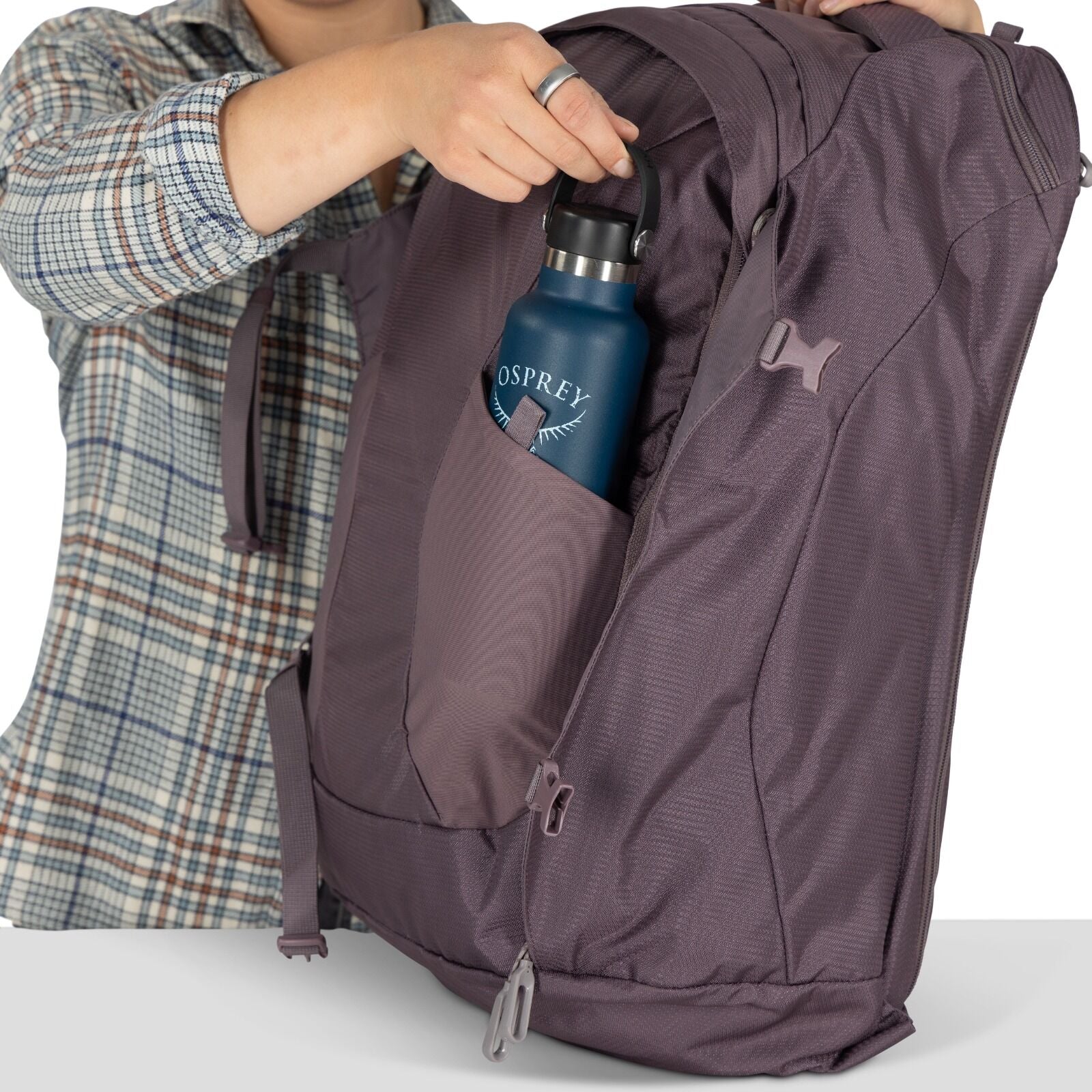 A model showing detailed images of the Fairview 40 Travel pack in the color Graphite Purple.