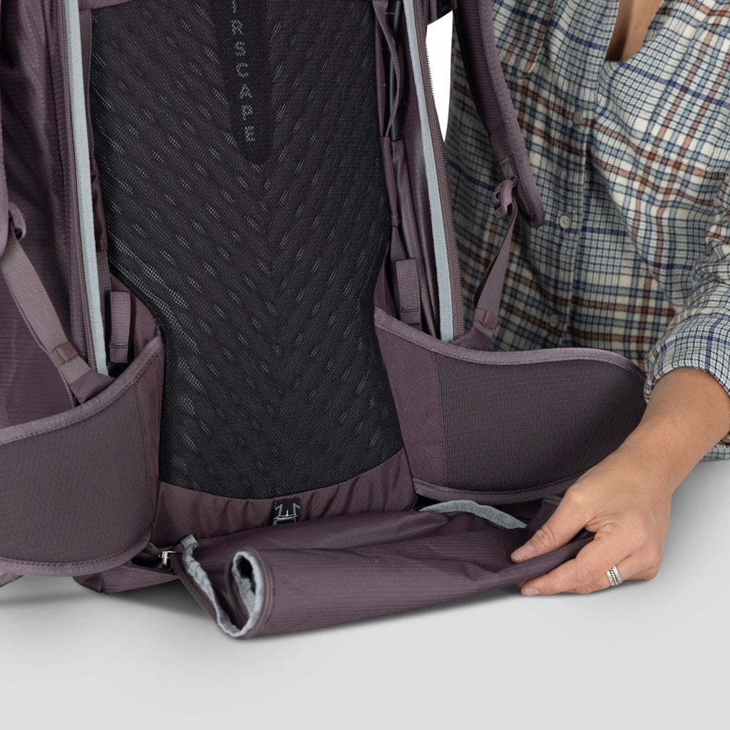 A model showing detailed images of the Fairview 40 Travel pack in the color Graphite Purple.