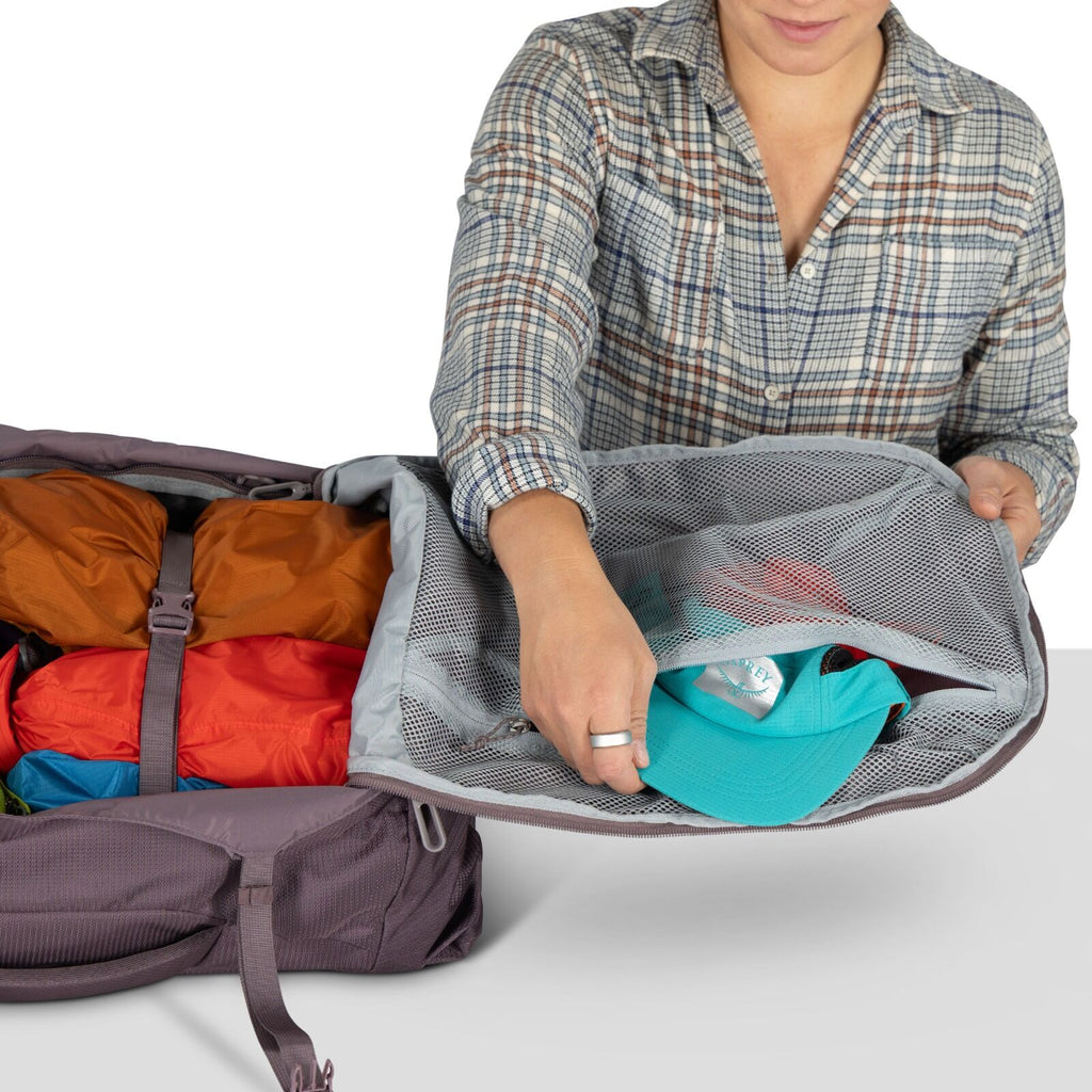 A model showing detailed images of the Fairview 40 Travel pack in the color Graphite Purple.