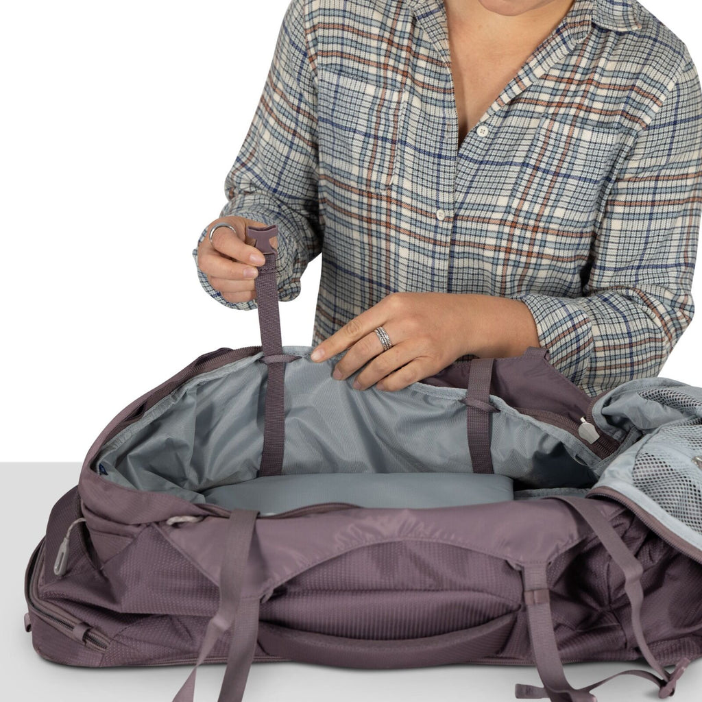 A model showing detailed images of the Fairview 40 Travel pack in the color Graphite Purple.