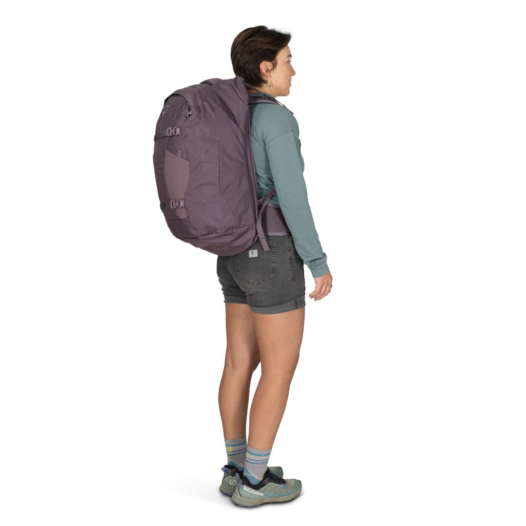 Image of a person modeling the Fairview 40 Travel pack in the color Graphite Purple.