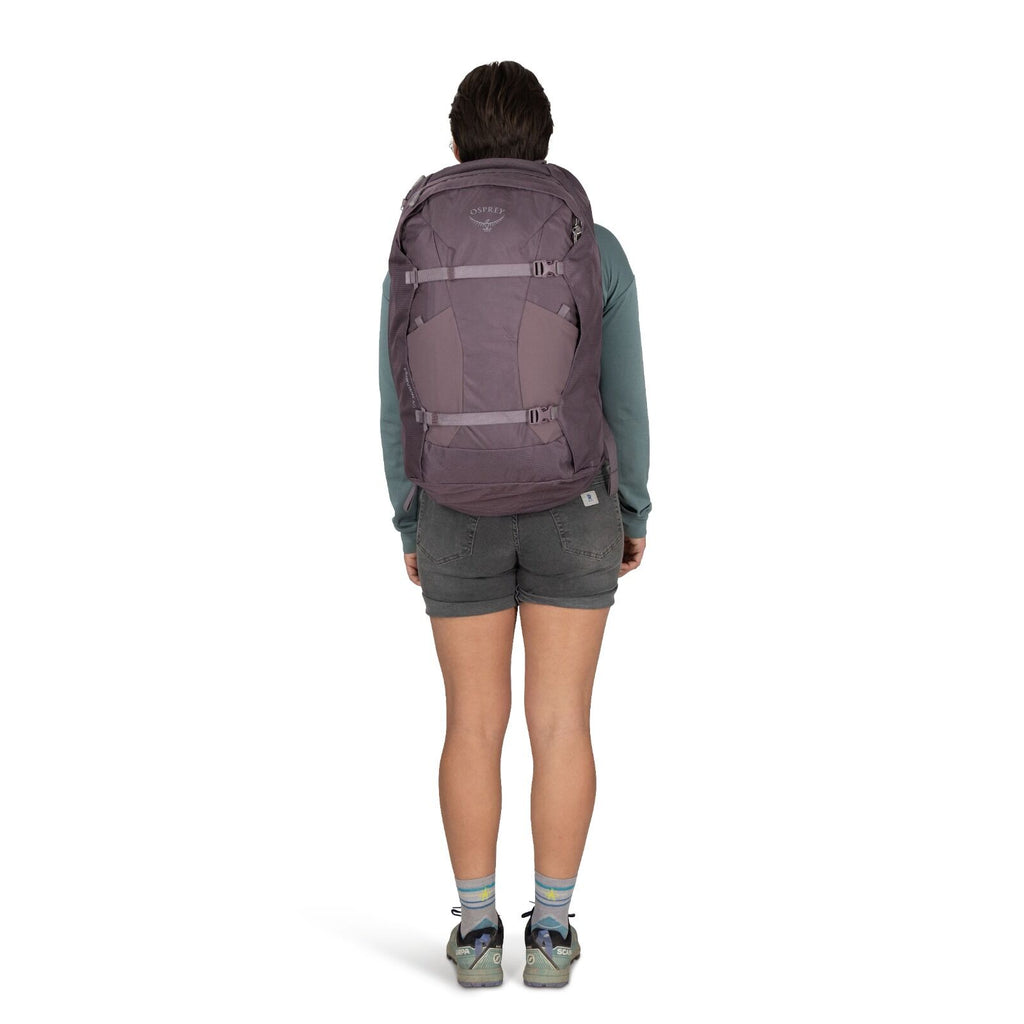 Image of a person modeling the Fairview 40 Travel pack in the color Graphite Purple.