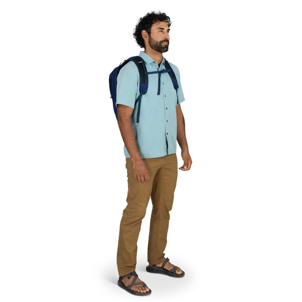 Model wearing the Osprey Farpoint 70 Travel pack in the color Antique Blue