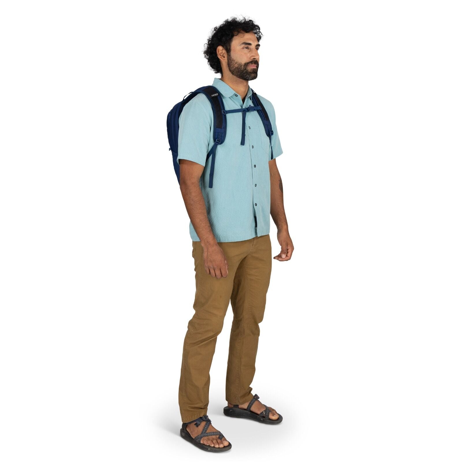 Model wearing the Osprey Farpoint 70 Travel pack in the color Antique Blue