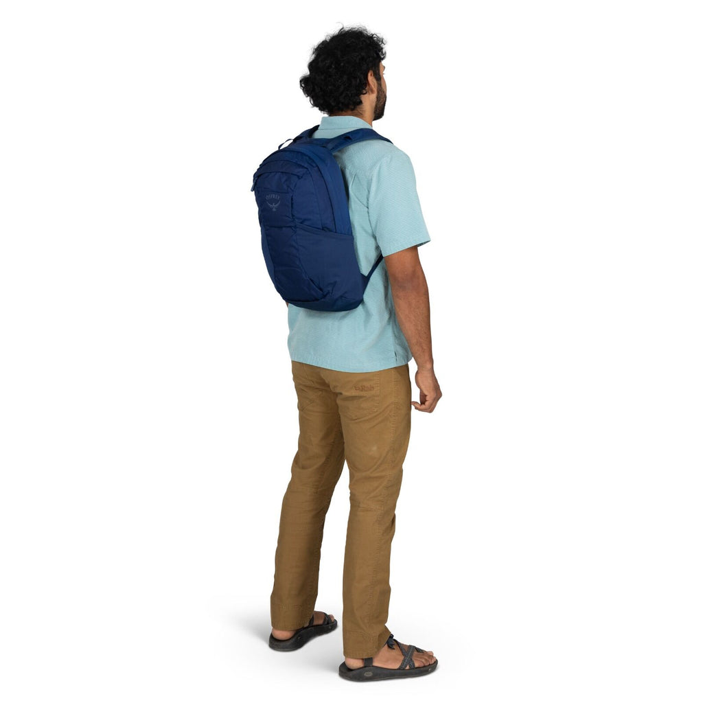 Model wearing the Osprey Farpoint 70 Travel pack in the color Antique Blue
