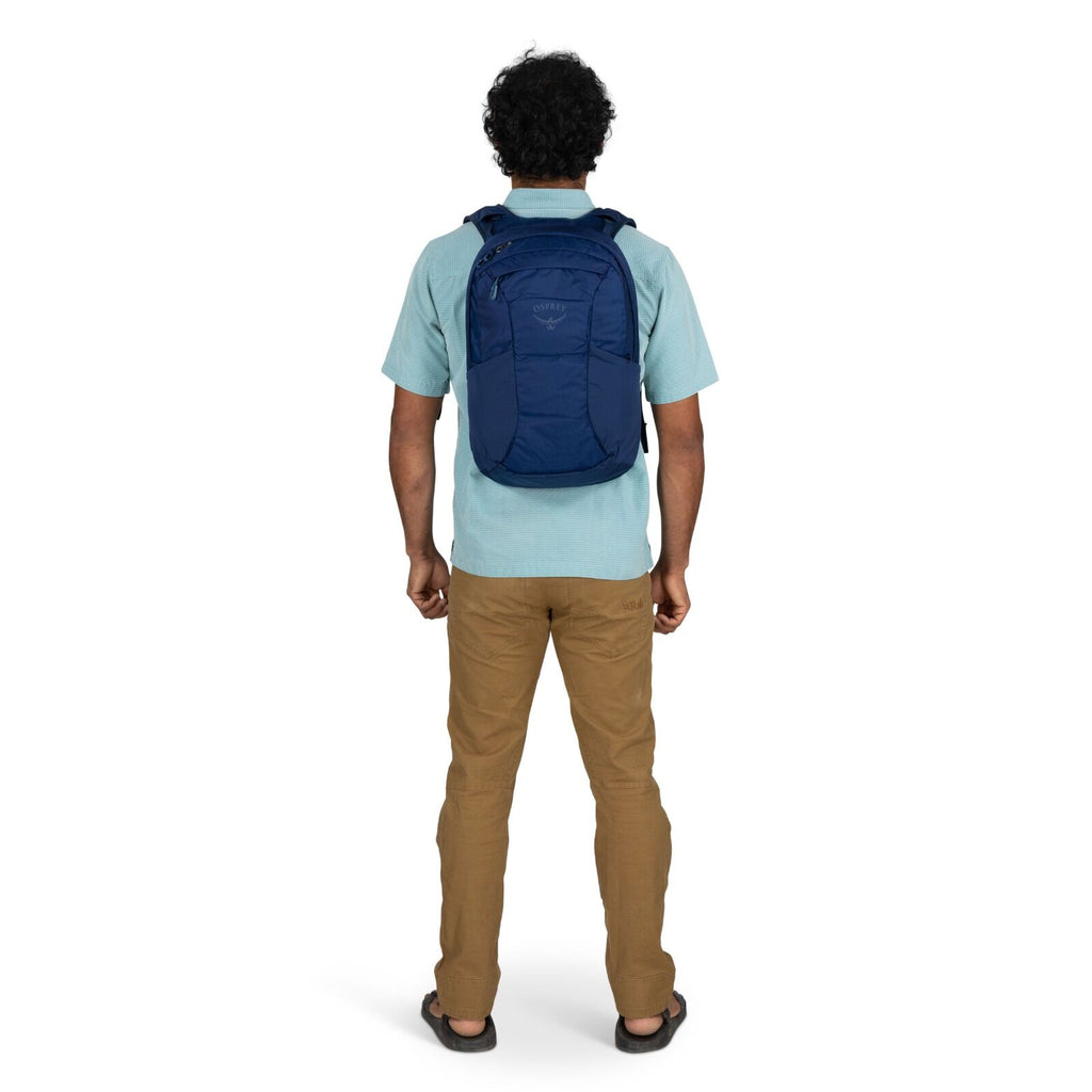 Model wearing the Osprey Farpoint 70 Travel pack in the color Antique Blue