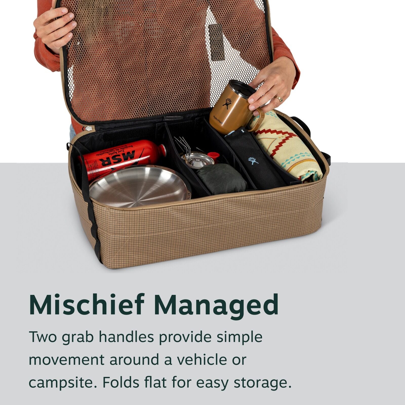 Open camping organizer filled with gear like a mug, blanket, and utensils. Text below reads "Mischief Managed" with a storage description.