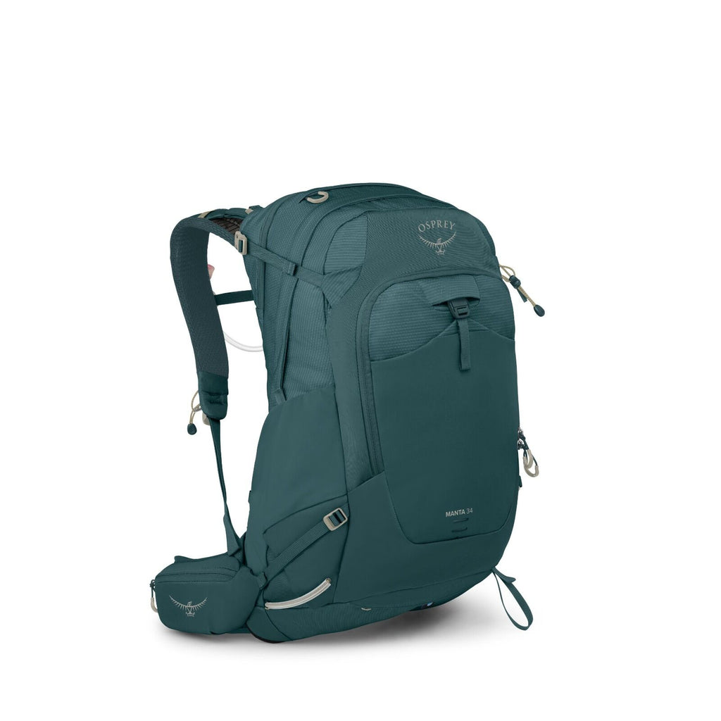 The image shows a teal-colored backpack from the brand Osprey, identified as the "Manta 34". It has a prominent front pocket with a zipper, adjustable padded shoulder straps, and a waist strap with pockets, which suggests it is designed for hiking or outd