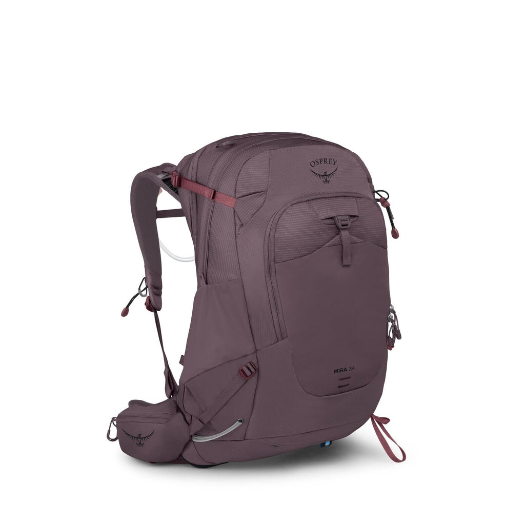 The image features an Osprey Mira 34 backpack designed for hiking or outdoor activities. It is predominantly plum-colored with several compartments and adjustable straps for securing the contents and ensuring comfort when worn. The backpack is equipped wi