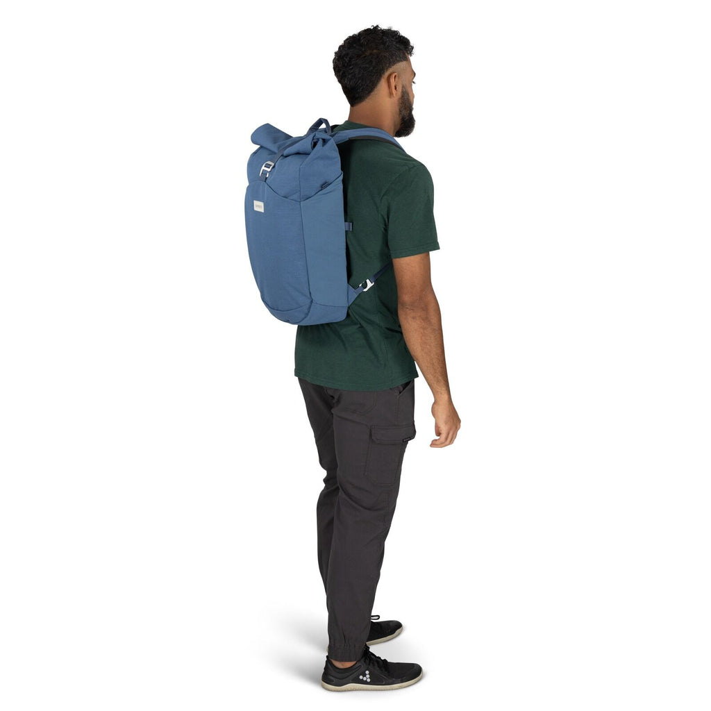 on-body image of the Arcane Roll top pack in the color Nircana Blue Heather