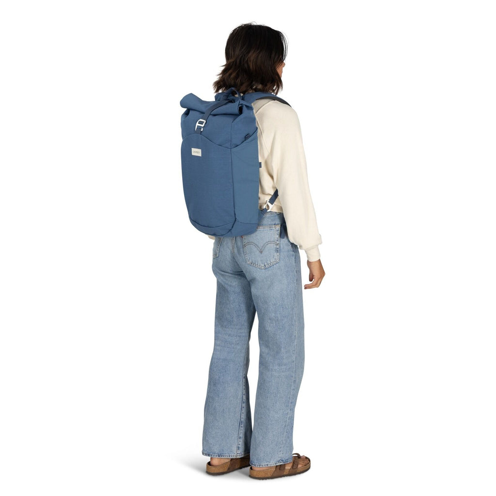 on-body image of the Arcane Roll top pack in the color Nircana Blue Heather