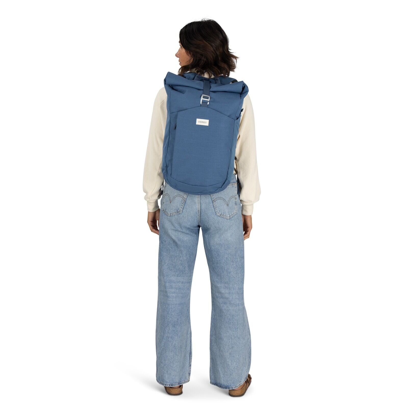 on-body image of the Arcane Roll top pack in the color Nircana Blue Heather