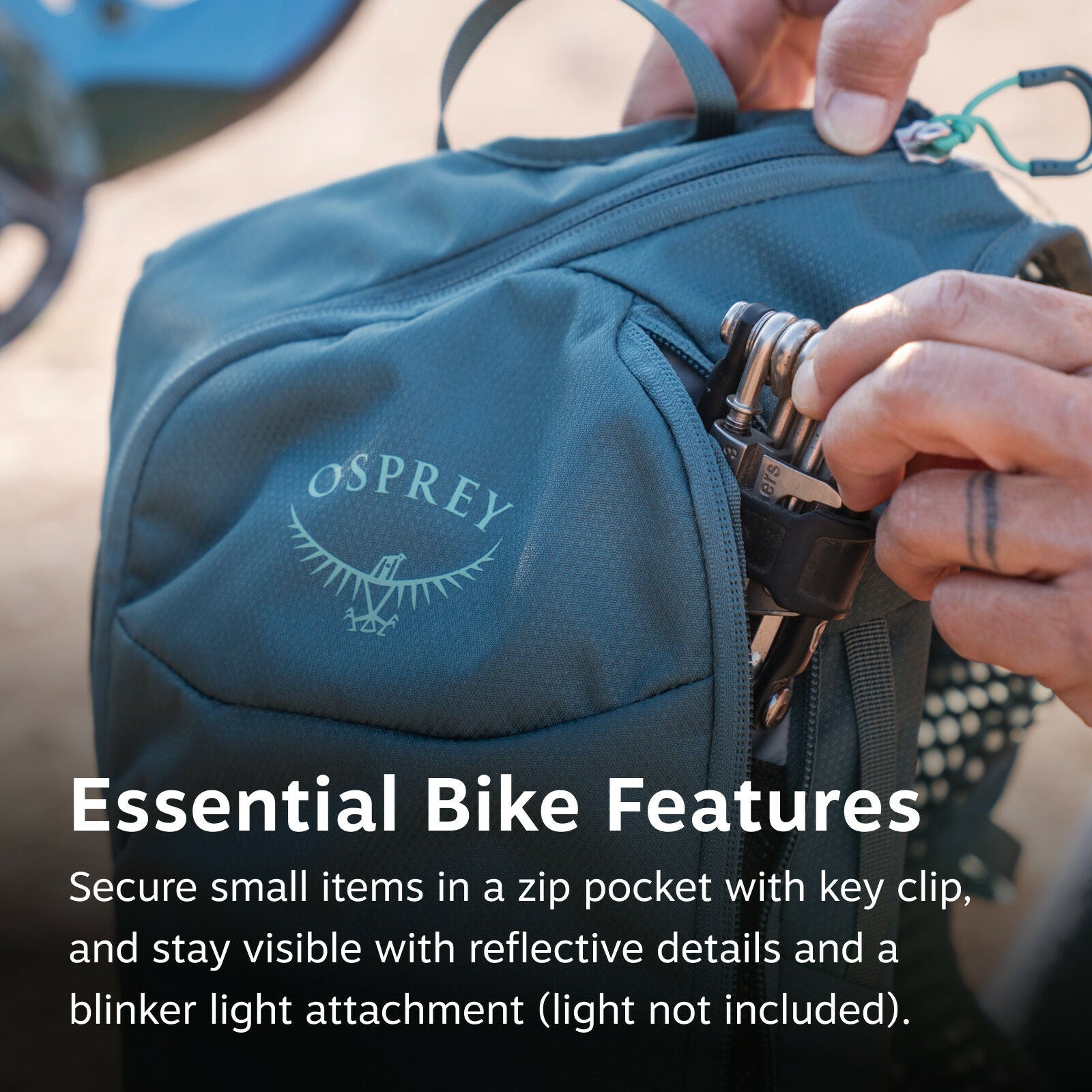 The image shows a close-up of a blue Osprey backpack, with the brand's logo visible on the front. A person is pulling out a multitool from a zippered pocket of the backpack, which is secured with a green key clip attached to the zipper. The text overlay o