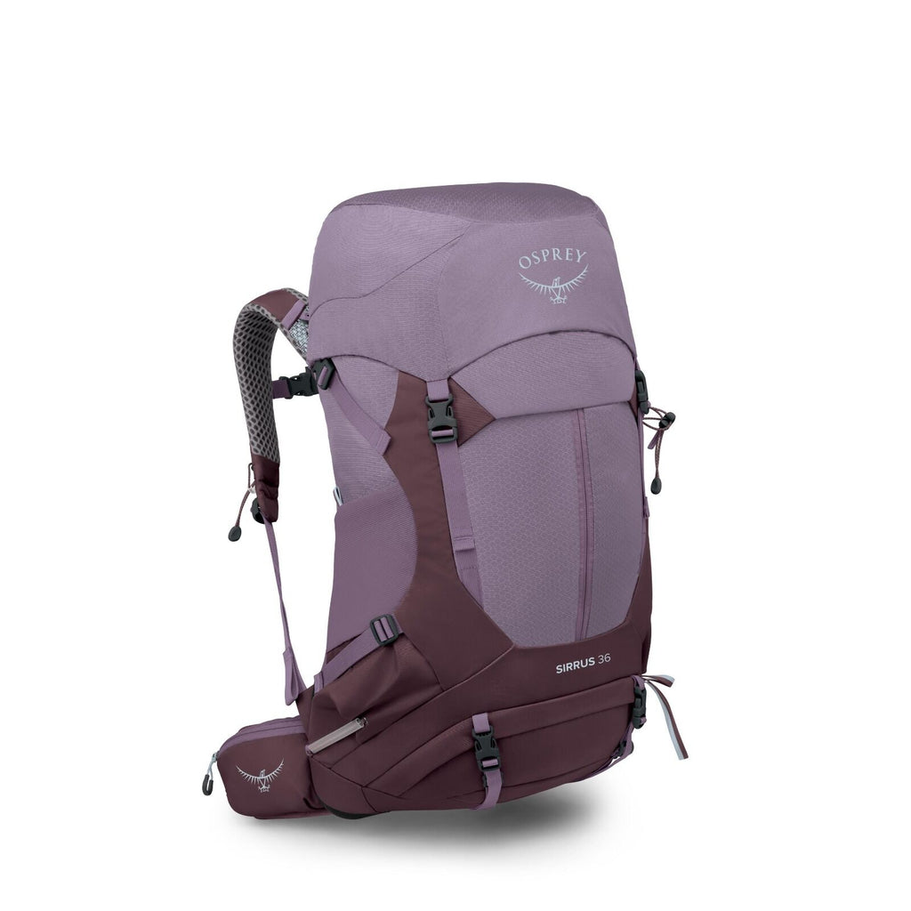 The image displays an Osprey Sirrus 36 hiking backpack in a purple color scheme with darker purple accents. The backpack features multiple compartments, adjustable straps, and padding for comfort during hikes. The Osprey logo, an emblem of a bird with out