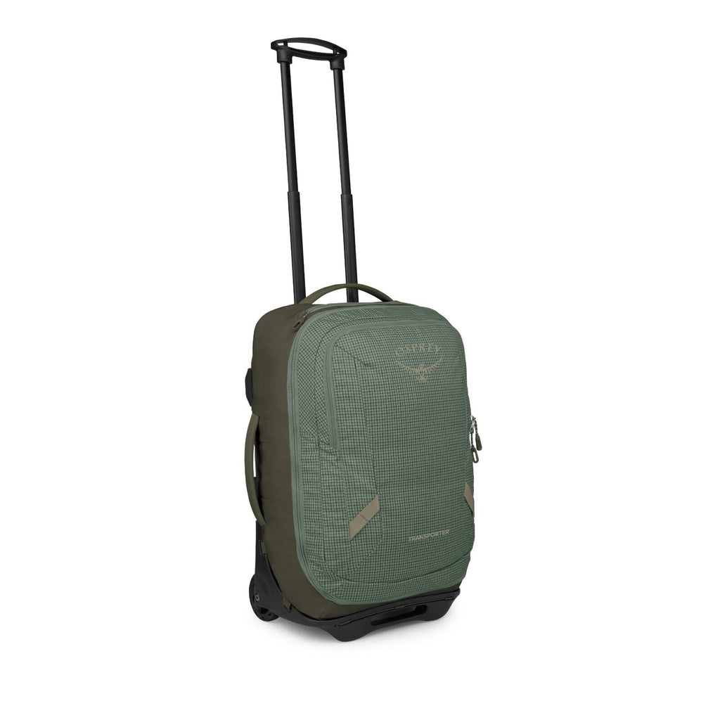 The images show a compact rolling travel bag in green with a subtle grid pattern. It features a telescoping handle, two wheels, and multiple grab handles on the top and side for easy carrying. The front has a zippered pocket with small reflective tabs and