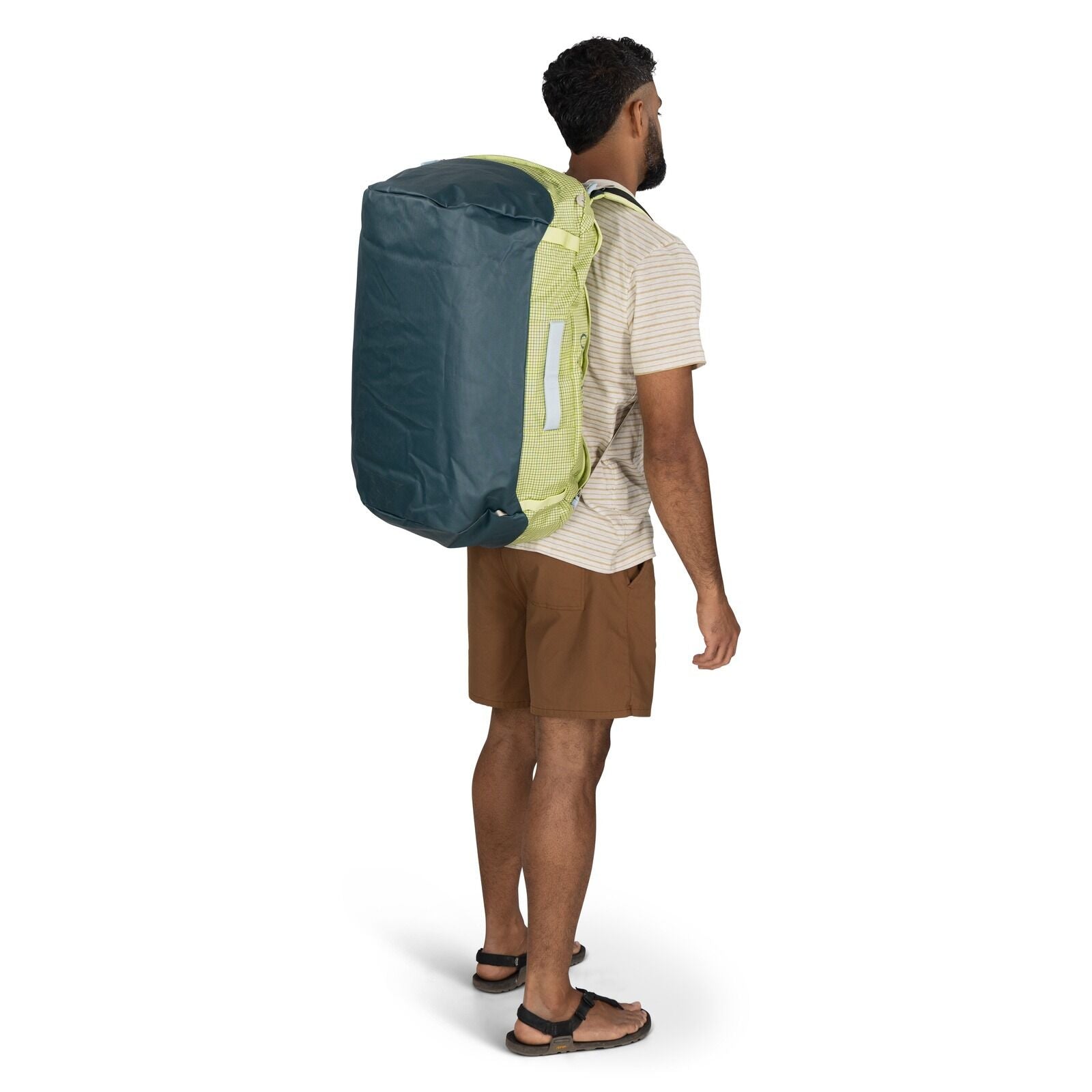 Model wearing the Osprey Tranpsorter Duffel 65 in the color Glow Dew