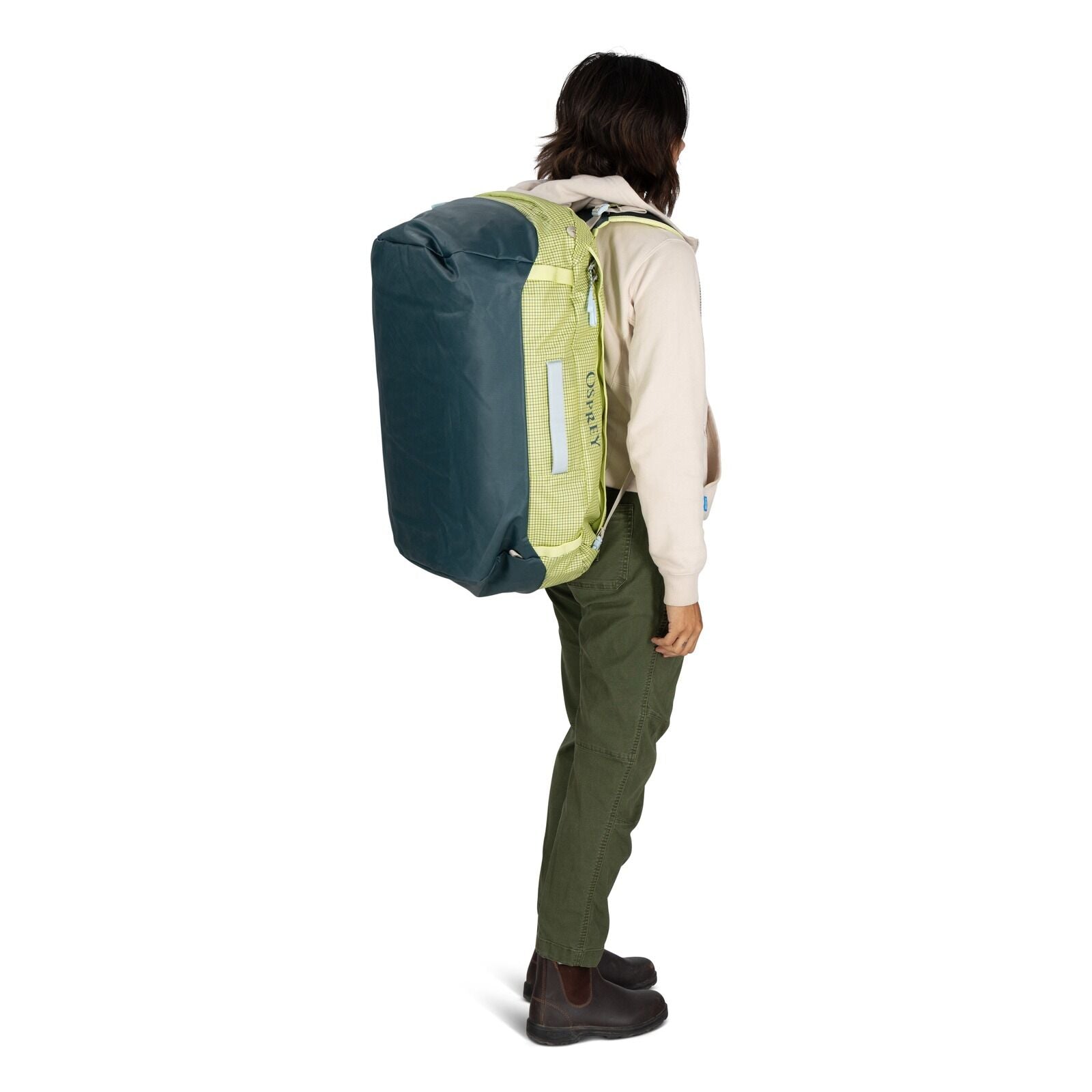 The image shows a woman wearing a large backpack.