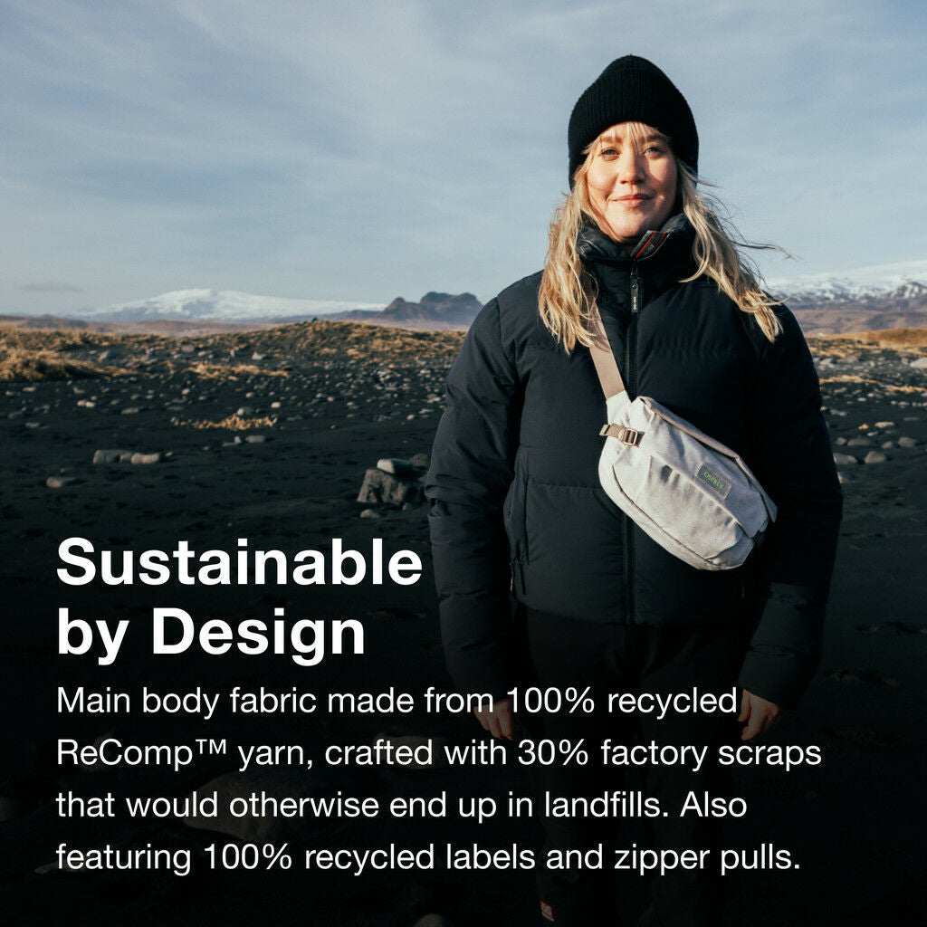 A person in winter clothing stands on a rocky landscape with text about sustainable materials.
